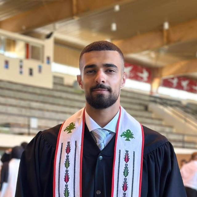 Osama Shalabi wearing his graduation gown and stole
